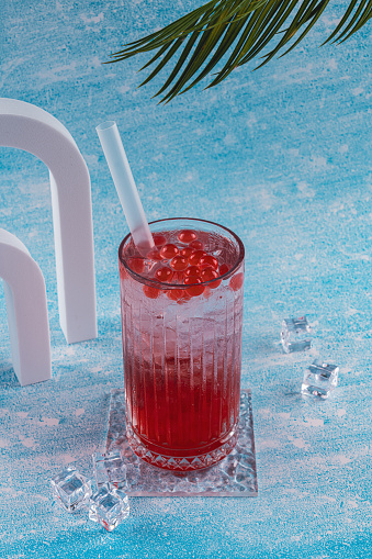 ice falls in a glass with color fruit drinks