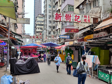 People walking at a street market selling fruit and vegetables in Canton road, Mongkok district, Kowloon peninsula.