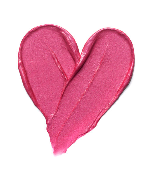 Pink lipstick shimmering texture in heart shape, texture stroke isolated on white background. Cosmetic product smear smudge swatch