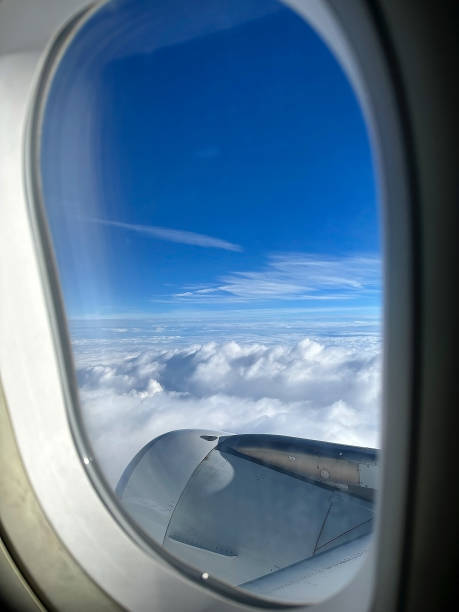 istock Airplane is flying among the white clouds in the blue sky 1725774233