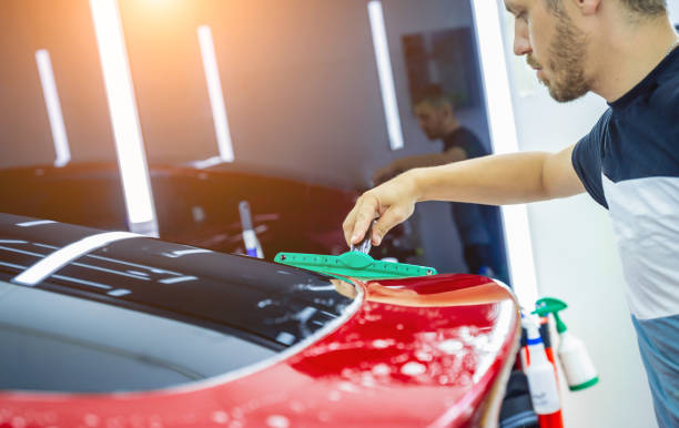 istock The process of installing protective film on the new red car. 1725779241
