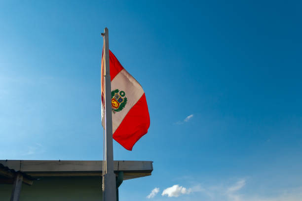 Red, white and blue: The Peruvian flag in the air stock photo