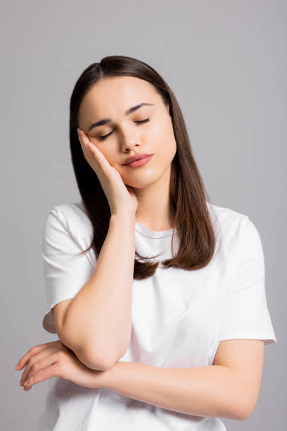 istock Sleepy young woman standing on grey background in studio isolated sleeping showing exhausted tired emotions 1725790978