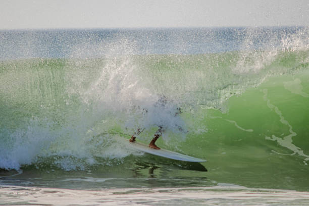 istock Surfer in a barrel falling under the force of the waves 1725792671