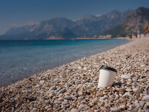 walk along Konyaalti embankment in Antalya, coffee to go near sea on beach.