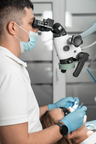 istock A professional dentist treats the patient's teeth using a special medical microscope. A modern dental clinic on professional equipment. Concept: prosthetics, implantation, correction 1725813163