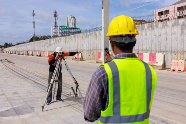 engineer use theodolite equipment working on construction site for route surveying.
