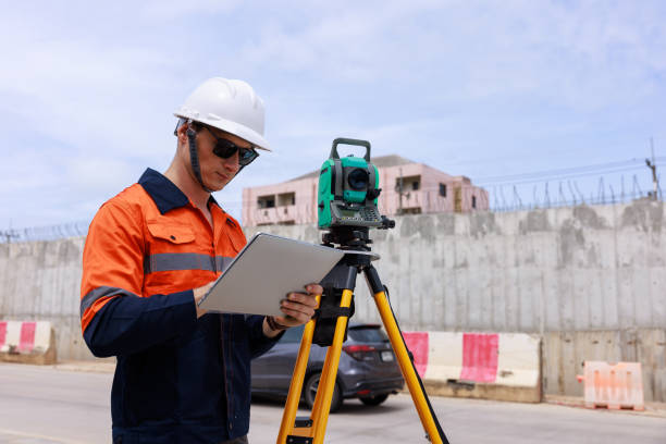 istock Engineer use theodolite equipment and looking blueprints on tablet construction project for route surveying 1725814261