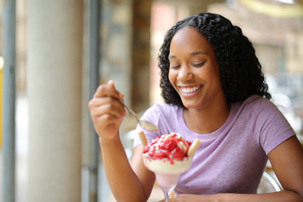 istock Happy black woman eating ice cream 1725819180