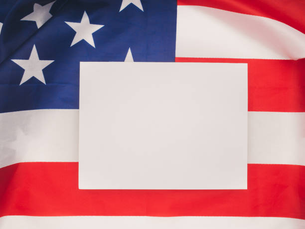 istock blank white paper over the American flag 1725824187
