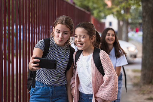School friends smiling when taking a selfie