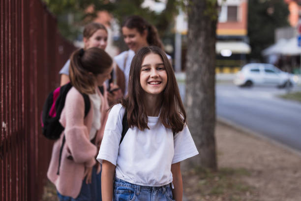 istock Laughing school girl going to school 1725830321