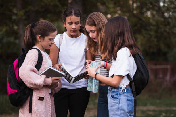 Group of school friends reading homework together