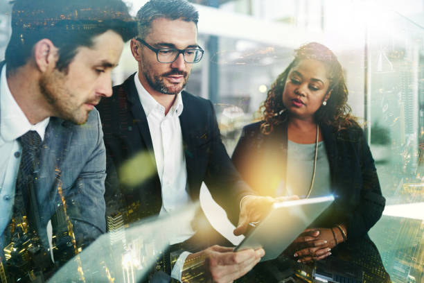 istock Planning, tablet and people with digital overlay for corporate strategy, collaboration and teamwork in finance. Stock market research, data analytics and business manager or employees in city office 1725849588