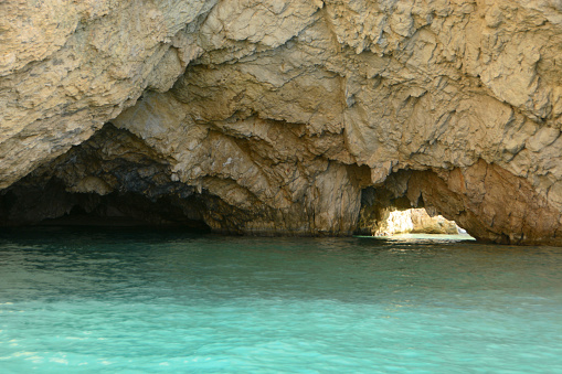 Zakynthos: Cap Marathia. Looking inside a small cave.