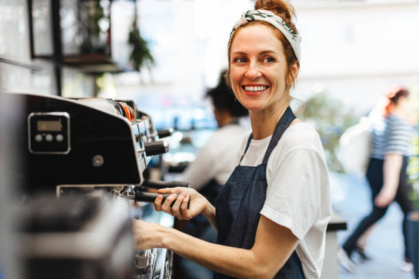 istock Happy waitress brewing fresh coffee for a customer in a coffee shop 1725873109