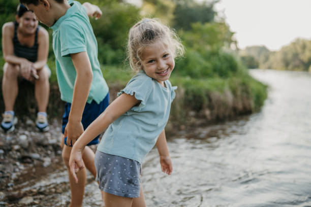 istock Boy and girl playing in river 1725891702