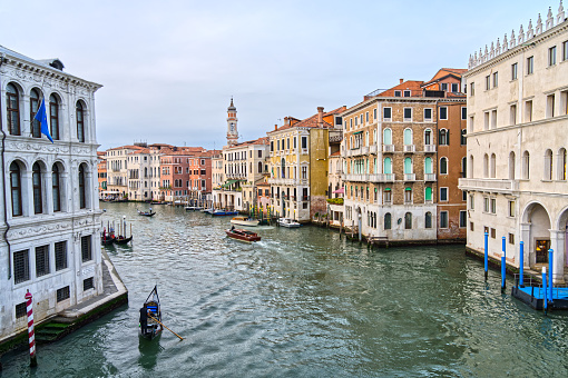 Venice, Italy - October 9th 2022:  View down Grand Canal to the many old Italian palaces and a vaporetto which is a sailing bus in the center of the old and famous Italian city Venice