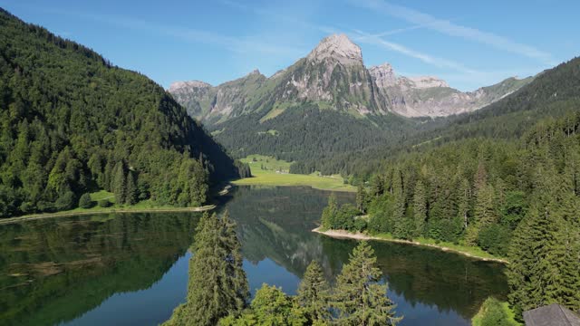 Local people in Switzerland living in green fresh air natural place in highlands of Alpine Swiss alps lots of green field and hiking plan to trip to mountain range pine tree forest calm lake nafels