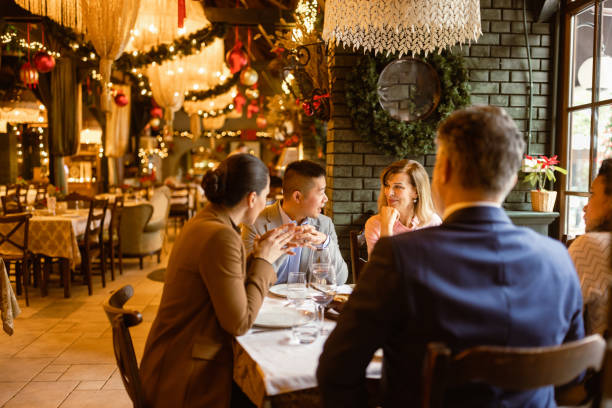 Business people having dinner in luxury restaurant stock photo