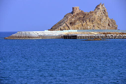 Riyam, Wilayat Muttrah, Muscat, Oman: Portuguese coastal defense tower at the harbor entrance, perched on a rocky promontory - used as protection against raids from Ottoman forces - Al-Bahri road, the corniche. Port Sultan Qaboos.