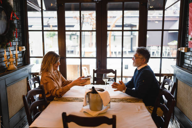 istock Senior couple having a Christmas dinner in luxury restaurant 1725973509