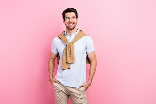 Photo of cheerful elegant man wear trendy beige clothes watching empty space seasonal sale proposition isolated on pink color background.