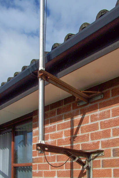 istock Stand-offs on a wall holding an aluminium pole for an antenna 1725988348