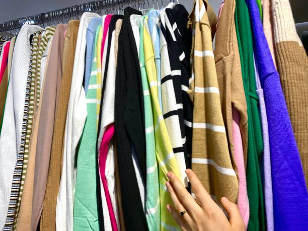 istock different colors and types of clothes in the store 1725988389