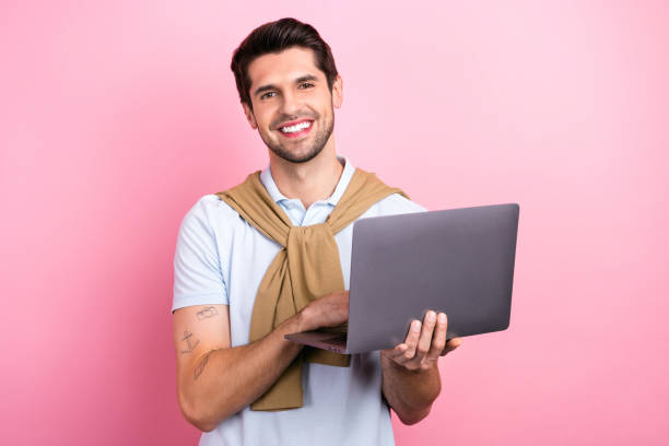 istock Photo of young man handsome expert technical support specialist hold netbook answer his clients chat isolated on pink color background 1725988419