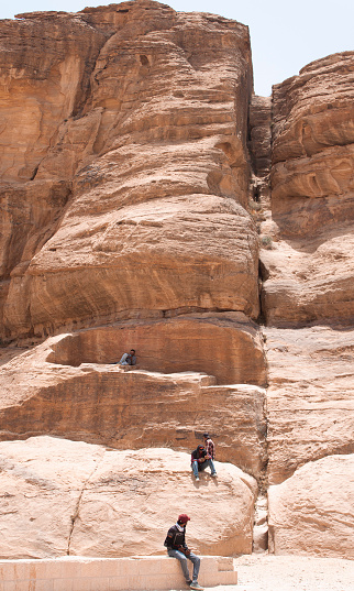 In Petra, Bedouins are often seen resting among the characteristic rock mountains of the ancient city. The intense heat makes it impossible to walk or stay under the sun for extended periods, therefore the Bedouins rest quite often in these places - like under the shadow provided by the few trees that are in Petra - to recover energy and continue with their daily activities for the day. The high temperatures pose a significant risk to the human health.