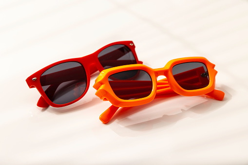 red and orange sunglasses on a desk