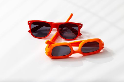 red and orange sunglasses on a desk