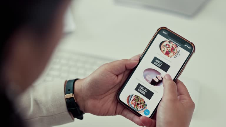 Person, phone and hands scrolling for food delivery, online order and customer shopping for lunch, meal or takeout at work. Mobile app, menu and hungry employee with choice or decision of dinner