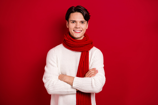 Portrait of cheerful nice person beaming smile crossed arms isolated on vibrant red color background.