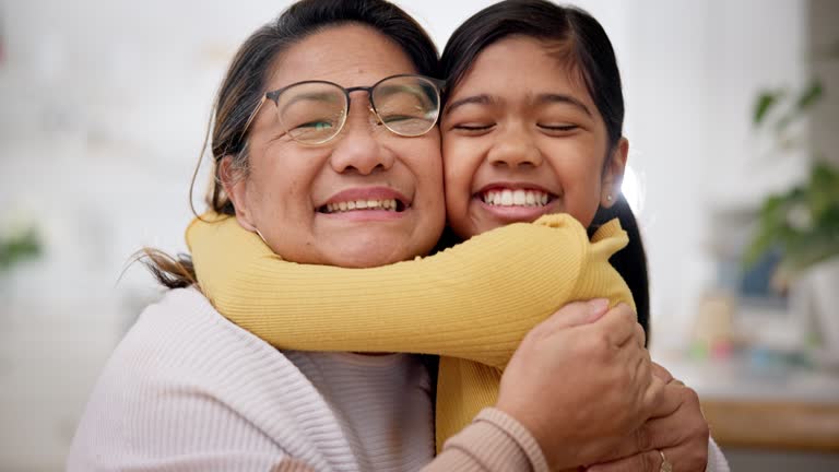 Child, grandmother and hug in home with smile, love and care with bonding and embrace. House, happy and young girl together with a senior woman with family support of grandma and kid with youth