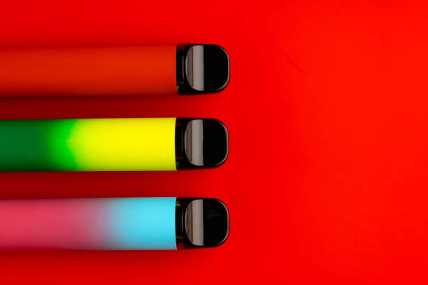istock Disposable electronic cigarettes on red background close up 1726049039