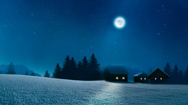 istock Snowy village with lighted windows in a cold winter night 1726051207