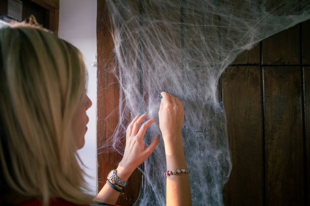 istock Woman decorating house for hallowe 1726051839