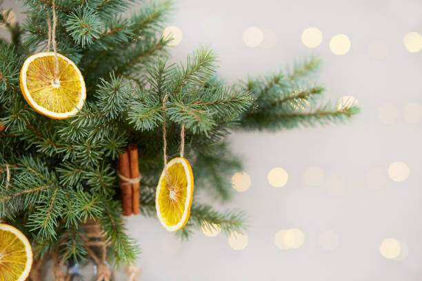 istock Eco friendly organic decor with dried orange and and cinnamon sticks on Christmas tree. DIY ornaments, zero waste concept. 1726054824