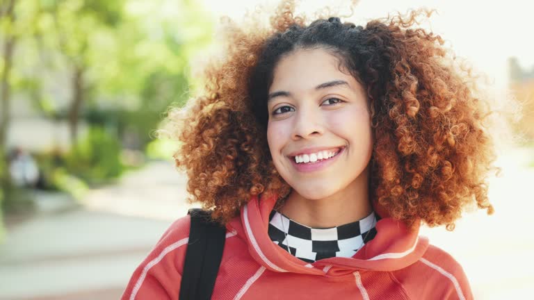 Latina student in campus, looking at camera and smiling