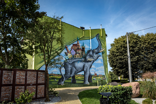 Trzebiatow, Poland - September 18, 2023: Modern mural with elephant on the wall in historical city center.