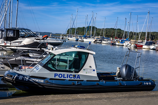 Kamien Pomorski, Poland - September 14, 2023:  Police motorboat moored at the harbour in Kamien Lagoon (Zalew Kamienski).