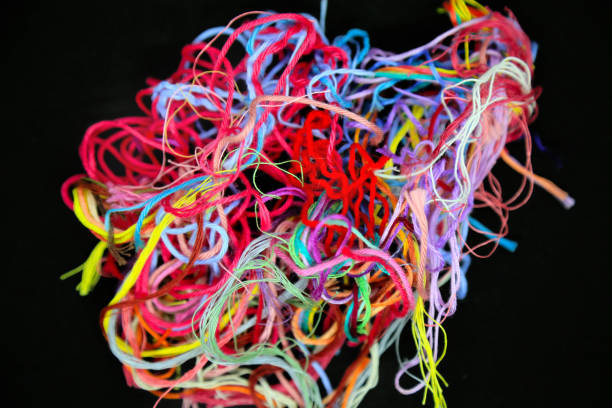 istock Ball of multicolored tangled threads for needlework on black background 1726069488