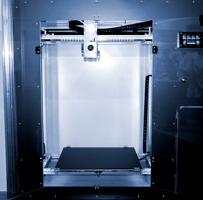 Empty 3d printer close-up. 3d printer with empty desktop inside. Non-printing open 3dprinter. Cope space. Progressive additive modern 3D printing technology. High-precision 3D printing technologies