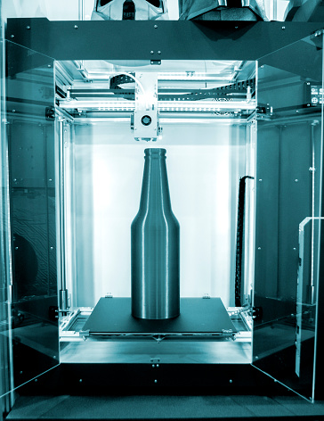 Object green gray bottle printed on 3D printer close-up, inside desktop of 3d printer. Progressive modern additive technology. Concept 4.0 industrial revolution. Modern 3D printing additive technology
