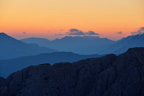 Mountain peaks during sunrise in the clouds on a beautiful morning in the Dolomites, Italy