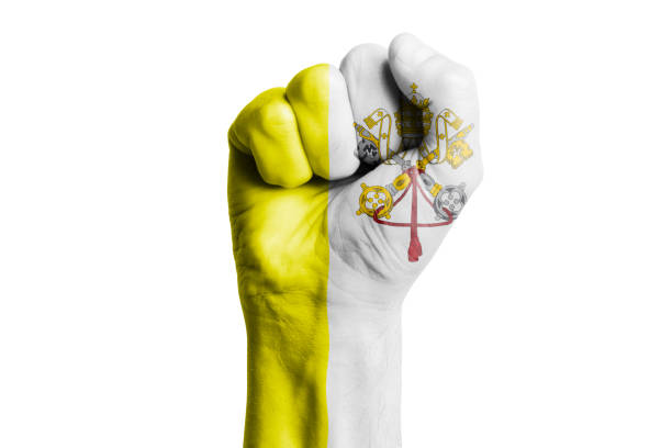 Man hand fist of VATICAN flag painted. Close-up