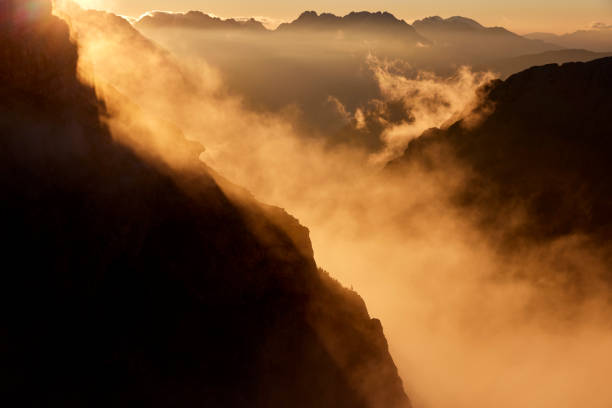 Mountain peaks during sunrise in the clouds on a beautiful morning in the Dolomites, Italy