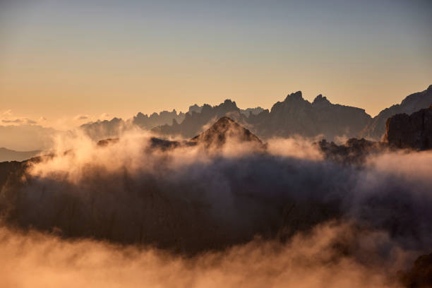 istock Mountain peaks during sunrise in the clouds 1726087135